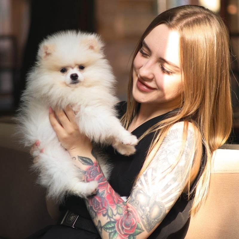 Woman holding fluffy dog